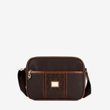 A dark brown crossbody camera bag with a front zippered pocket, featuring a textured embossed panel, a gold-tone square logo plate, and a matching dark brown shoulder strap #color_darkbrown / saddlebrown