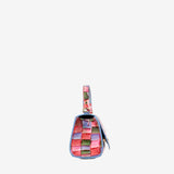 A small woven leather shoulder bag with a multicolor checkered pattern of pink, red, green, and blue squares, featuring a matching woven strap and a blue leather trim, shown against a plain light gray background. #color_pink