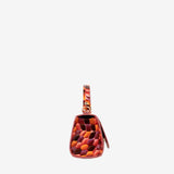 A small structured handbag with a glossy embossed pebble pattern in shades of orange, red, and brown, featuring a matching top handle and a small leather tag, shown against a plain light gray background. #color_orange