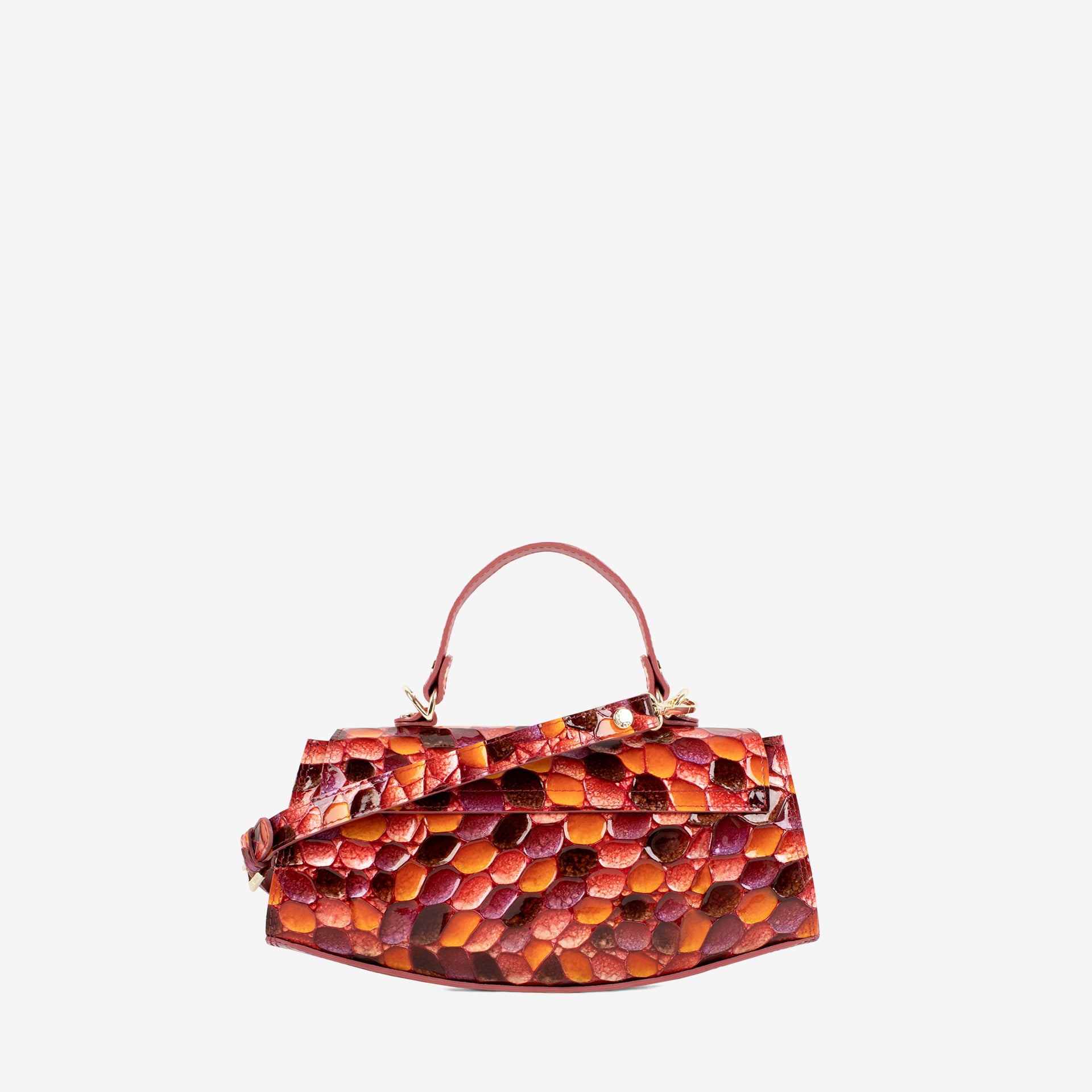 A small structured handbag with a glossy embossed pebble pattern in shades of orange, red, and brown, featuring a matching top handle and a small leather tag, shown against a plain light gray background. #color_orange