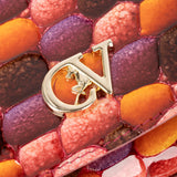 A small structured handbag with a glossy embossed pebble pattern in shades of orange, red, and brown, featuring a matching top handle and a small leather tag, shown against a plain light gray background. #color_orange